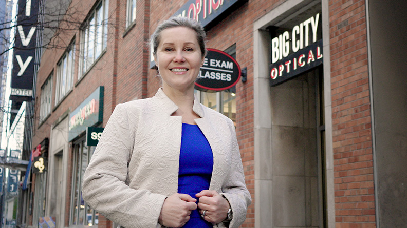 Dr. Rasa smiling in front of Big City Optical